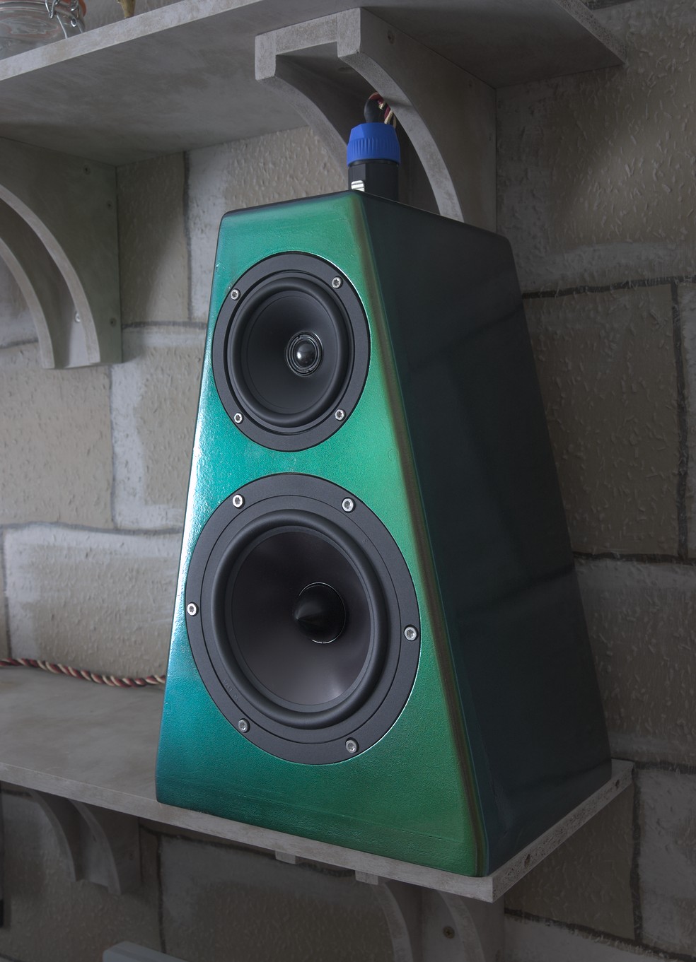 A completed speaker sitting on a shelf.
