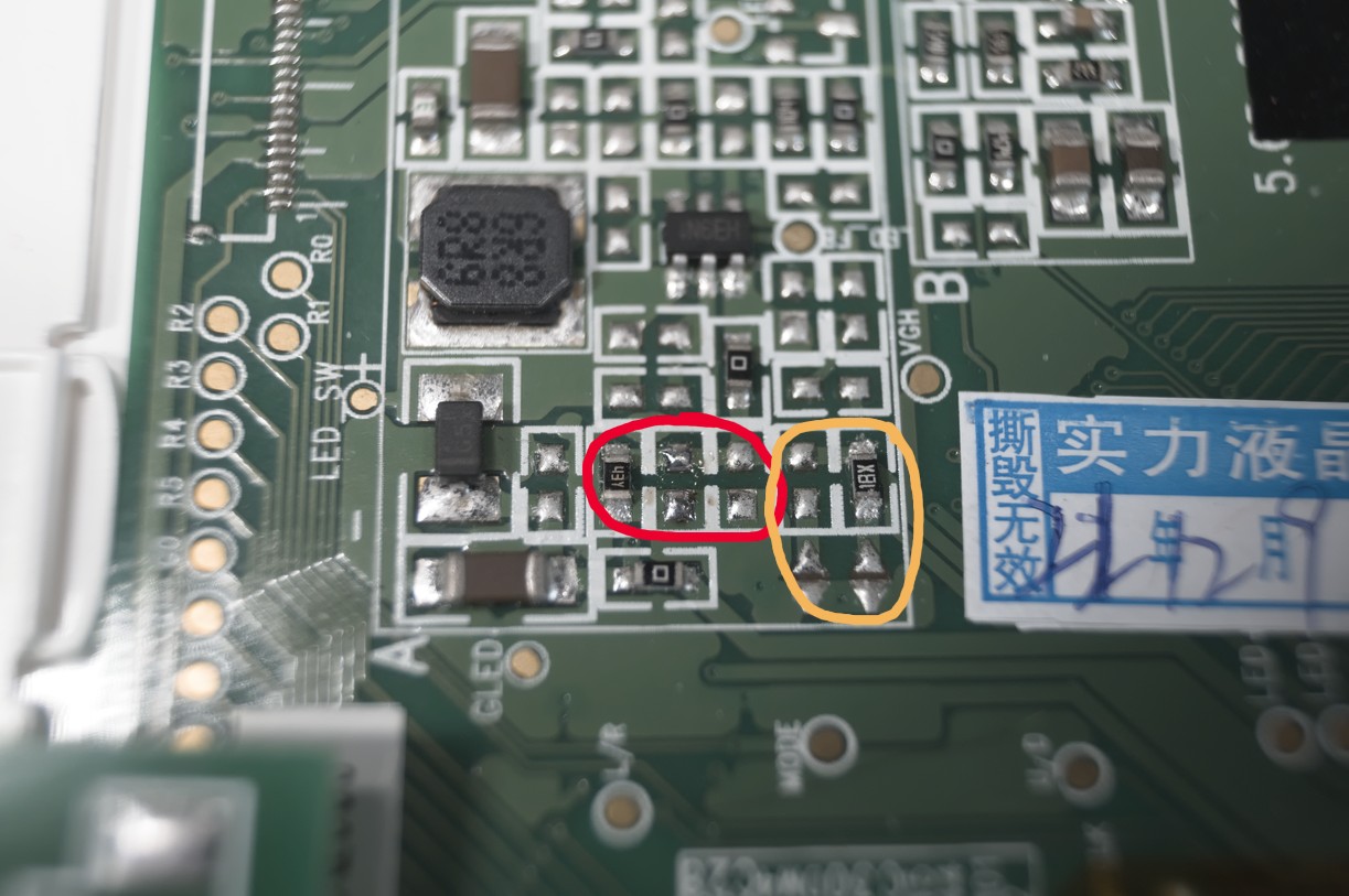 A close-up of the PCB behind the LCD panel. There are some SMD resistors and other components packed neatly into a square. Some of the resistors have been circled.
