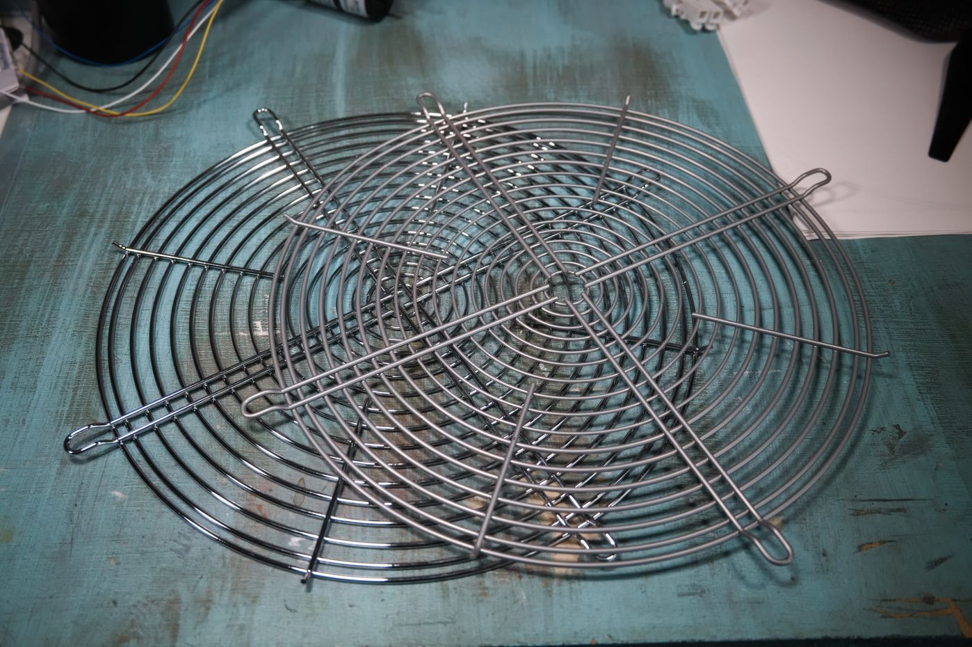 Two grilles. They consist of concentric rings of metal wire held together by four radial metal wires.