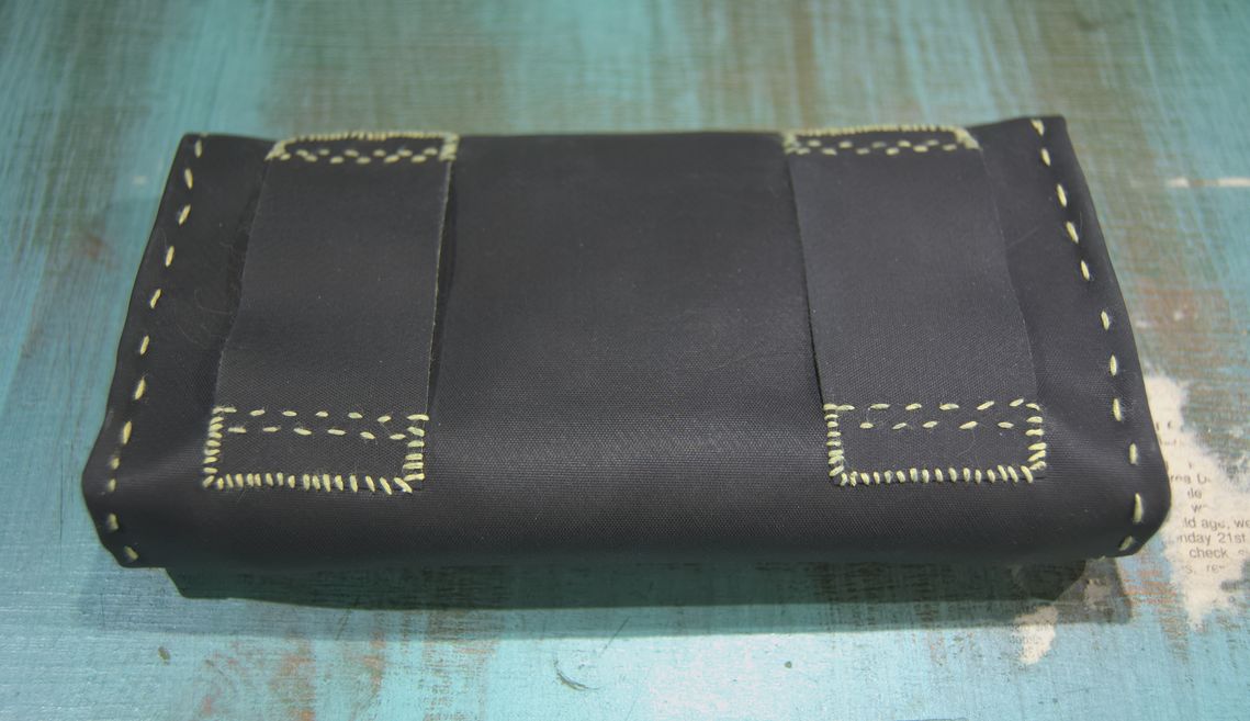 The back of the pouch, with a belt loop on each side.